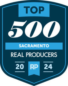 A blue and white badge with the words " top 5 0 0 sacramento real producers 2 0 1 4 ".